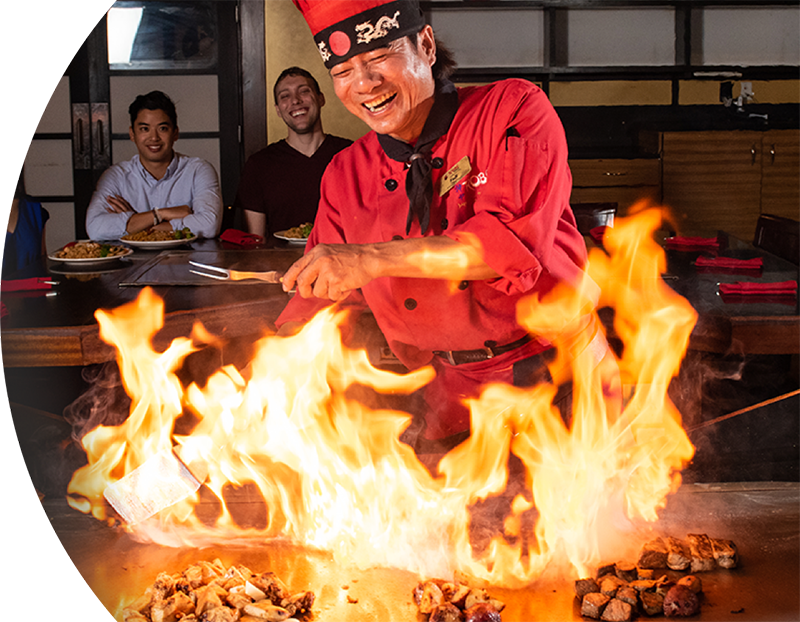 Kobe's Chef enjoying while cooking meat in front of customers