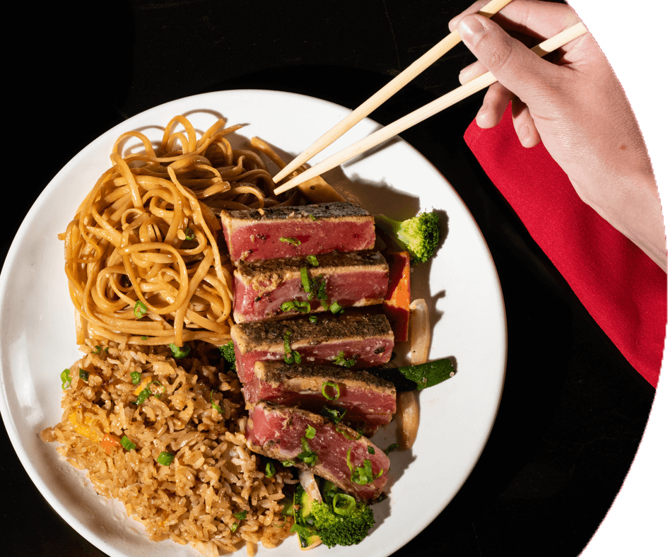 Person using chopsticks to eat a Kobe beef dinner