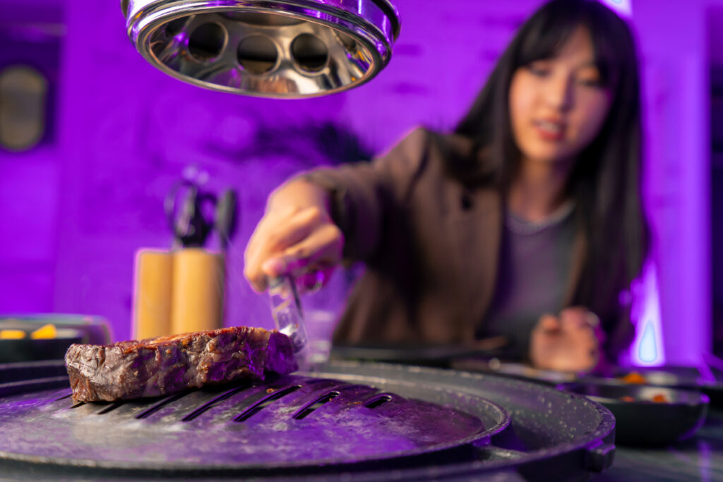 Girl cooking steak on hibachi vs teppanyaki grill