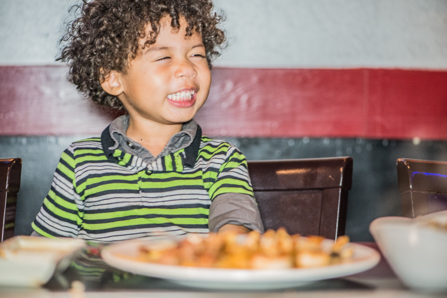 Kid with plate of chicken teriyaki