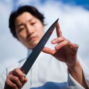 Japanese Chef examining types of Japanese Knives